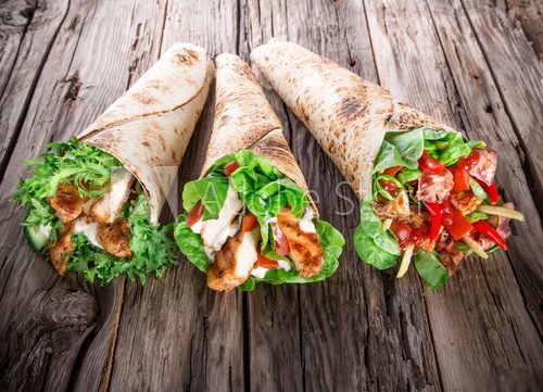 Chicken slices in a Tortilla Wrap on wood. 