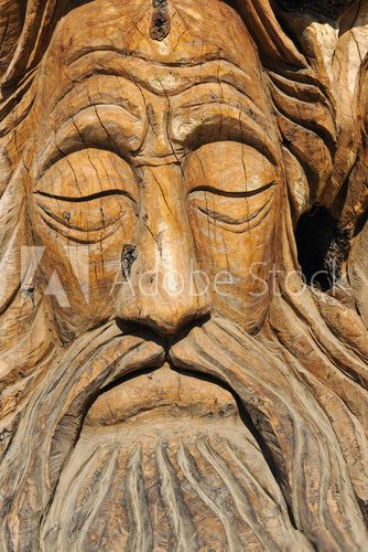 Face carved into an olive tree trunk in Matala
