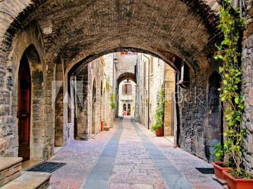Arched medieval street in the town of Assisi, Italy 