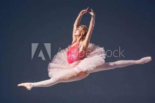Beautiful female ballet dancer on a grey background. Ballerina 
