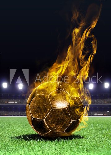 fiery soccer ball on field 