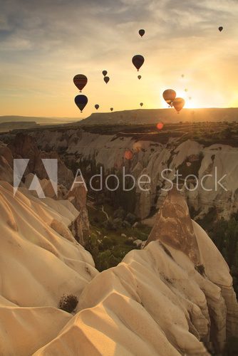 Hot air balloon over rock formations in Cappadocia, Turkey 