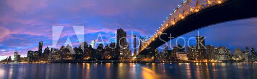 NYC Queensboro Bridge and Manhattan skyline panorama at dusk 