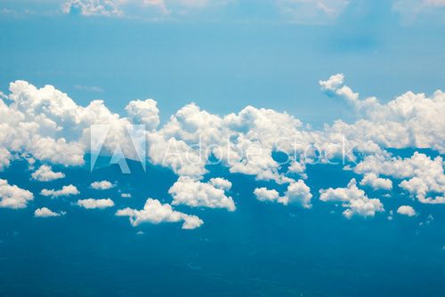 Ocean coastline, land, mountains and clouds airplane view 