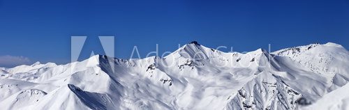 Panoramic view on off-piste slopes and blue sky at nice day 