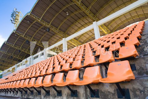 Stadium Orange Chair with roof and blue sky 
