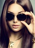 Beauty model girl with long brown hair wearing sunglasses 