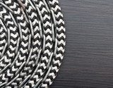 Metal chain and ship rope on dark wooden background