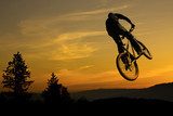 Mountain bike stunt against nice sunrise