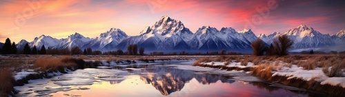 Captured in breathtaking panorama, the mountain range reveals its regal beauty under the canvas of a sunset sky.
