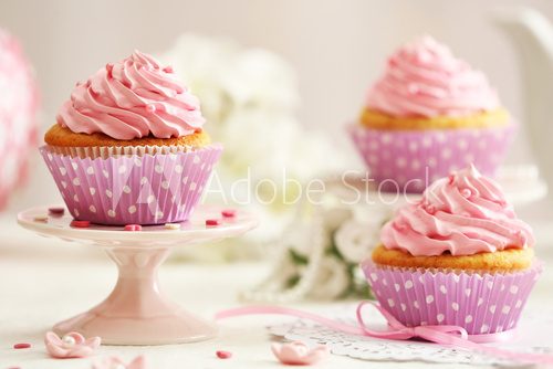 Delicious cupcakes on table on light background 