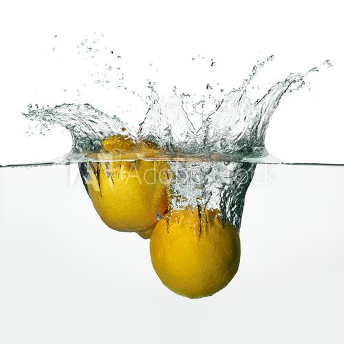 Fresh Lemons Splash in Water Isolated on White Background