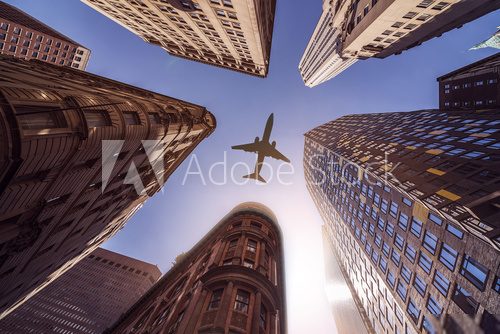 plane over highrise buildings