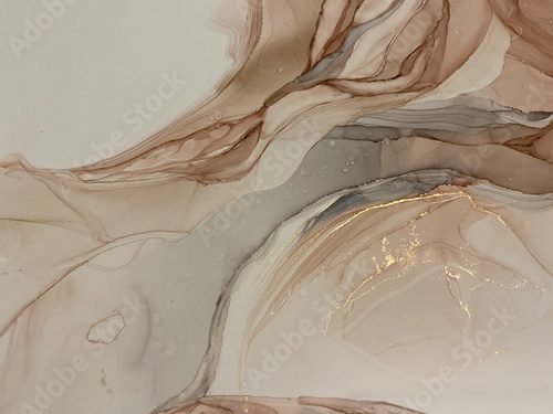 Abstract beige art with gold — pink background with brown, beautiful smudges and stains made with alcohol ink and golden pigment. Beige fluid art texture resembles petals, watercolor or aquarelle.