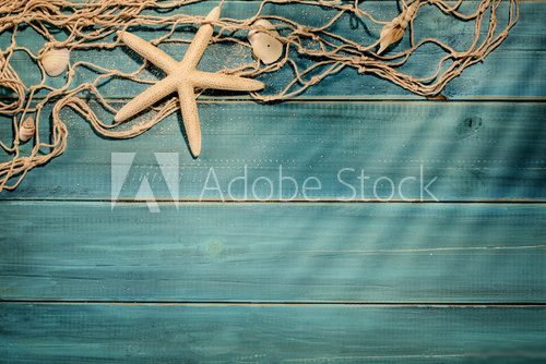 Aged deck with fish net and seashells