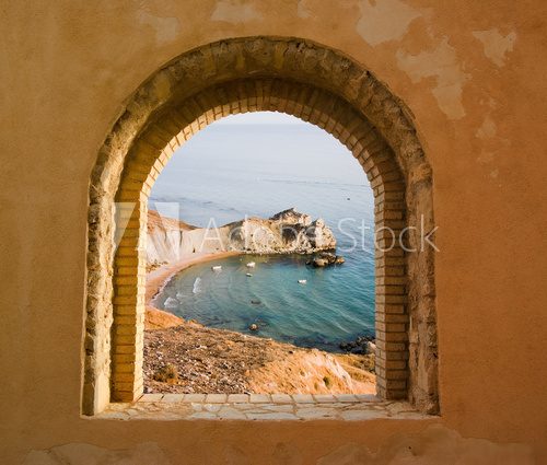 arched window on the coastal landscape of a bay