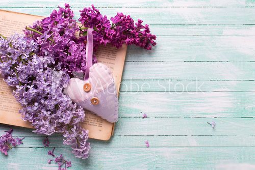 Background  with fresh lilac flowers on open vintage book and he