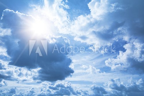 Bright blue sky background with white clouds and shining sun 