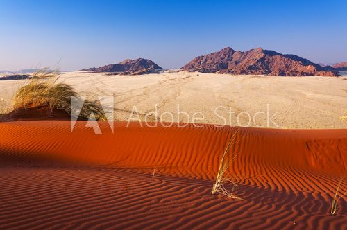 Detail of a red dune and mountains in Namibia, Africa