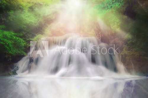 Light and waterfall in deep forest fantasy dream color 