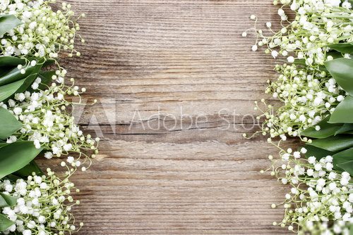 Lily of the valley flowers on wooden background.
