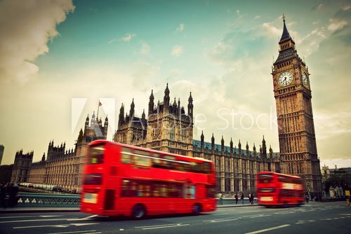 London, the UK. Red bus in motion and Big Ben 