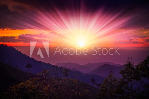 mountians and colour of sunrise,sunset behind light clouds