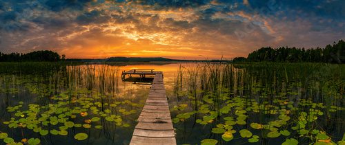 Panorama of beautiful sunrise over lake