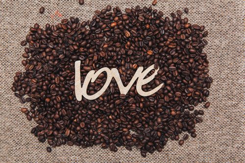 roasted coffee beans with the inscription love