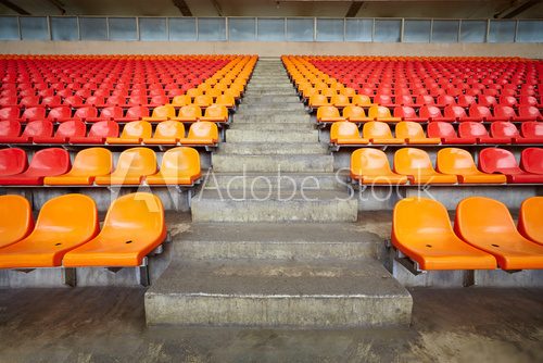 Rows of red and orange plastic sits at stadium 