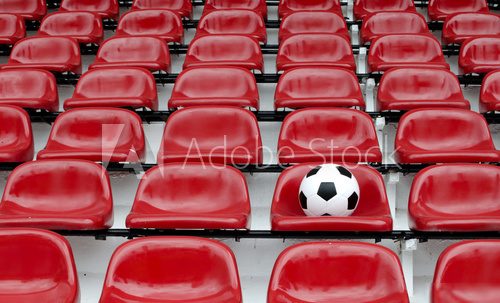 Rows of red football stadium seats with numbers 