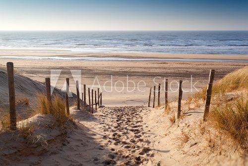 sand path to North sea at sunset
