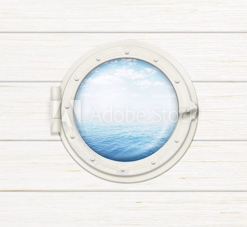 ship window or porthole on wooden wall with sea or ocean visible