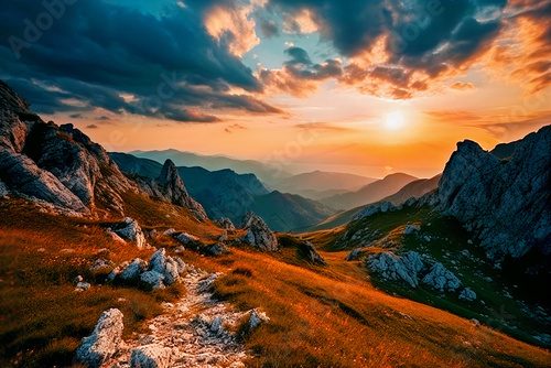 sunset in the mountains. orange and blue clouds in the sky above the peaks.