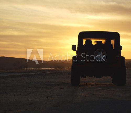 vehicle in the wilderness at sunset