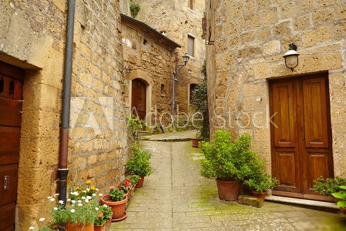 Vintage street decorated with flowers, Tuscany, Italy 