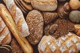 Bread background, top view of white, black and rye loaves