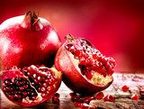 Pomegranates over Red Background. Organic Bio fruits