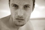 Portrait courageous man with sand on Face