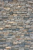 Ancient wall from slim granite brick. 