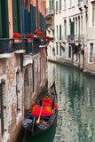 Backstreet canal Venice with empty gondola 