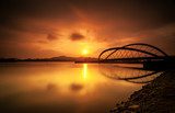 Curvy bridge in silhouette at sunrise in Putrajaya, Malaysia 
