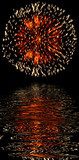 Explosive fireworks shooting into the black sky and reflections 