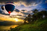 Hot air balloons floating over lake 