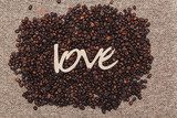 roasted coffee beans with the inscription love