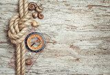 Ship rope, shells, compass and wood background