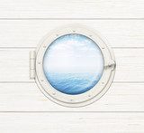 ship window or porthole on wooden wall with sea or ocean visible