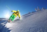 Skier against blue sky in high mountains 