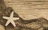 Starfish and fishnet on weathered  wood in sepia