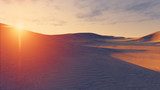 Sun sets behind the desert dunes